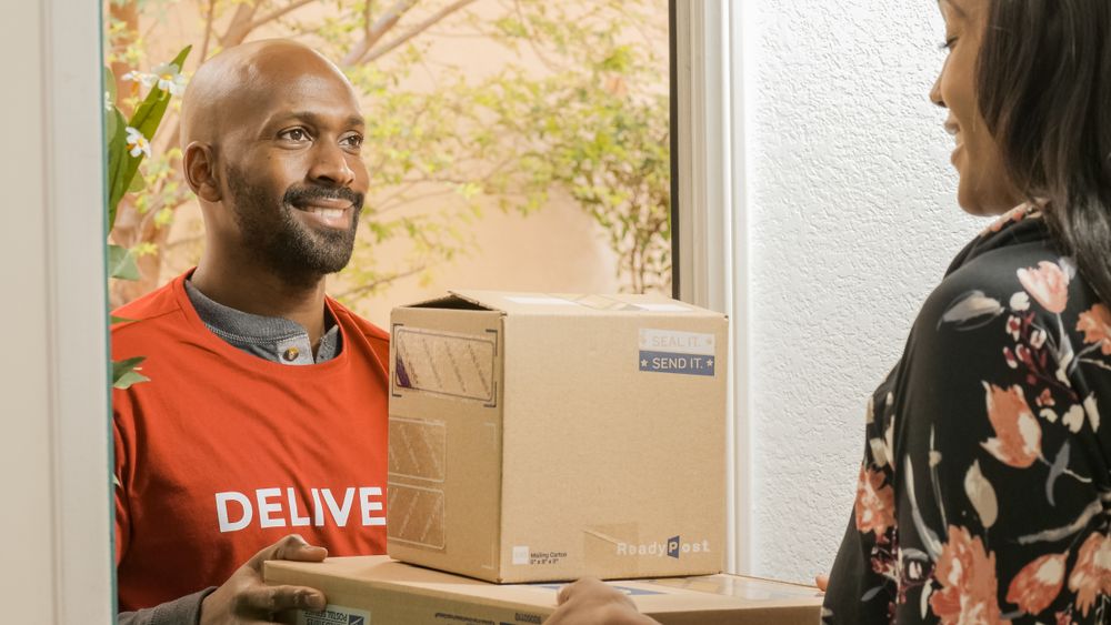 A courier handing over a finished order